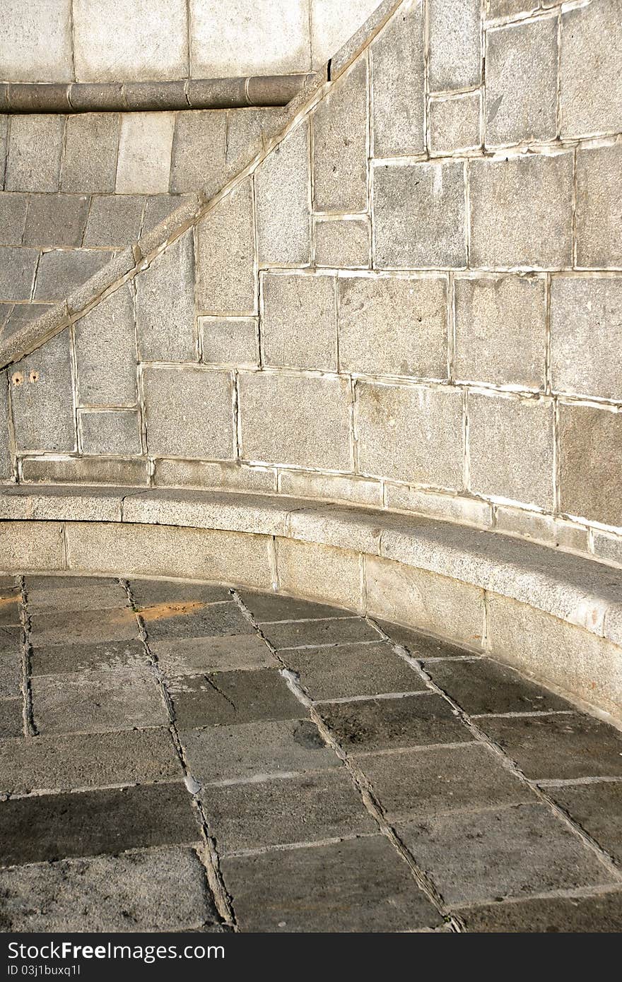 Close-up curve section of a granite stone wall and floor background