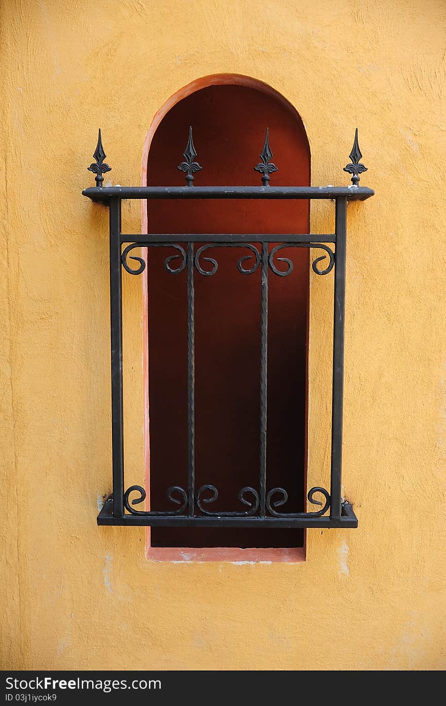 A building window covered with metal fence