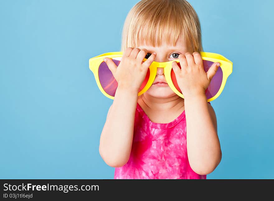 A little girl with a huge sunglasses