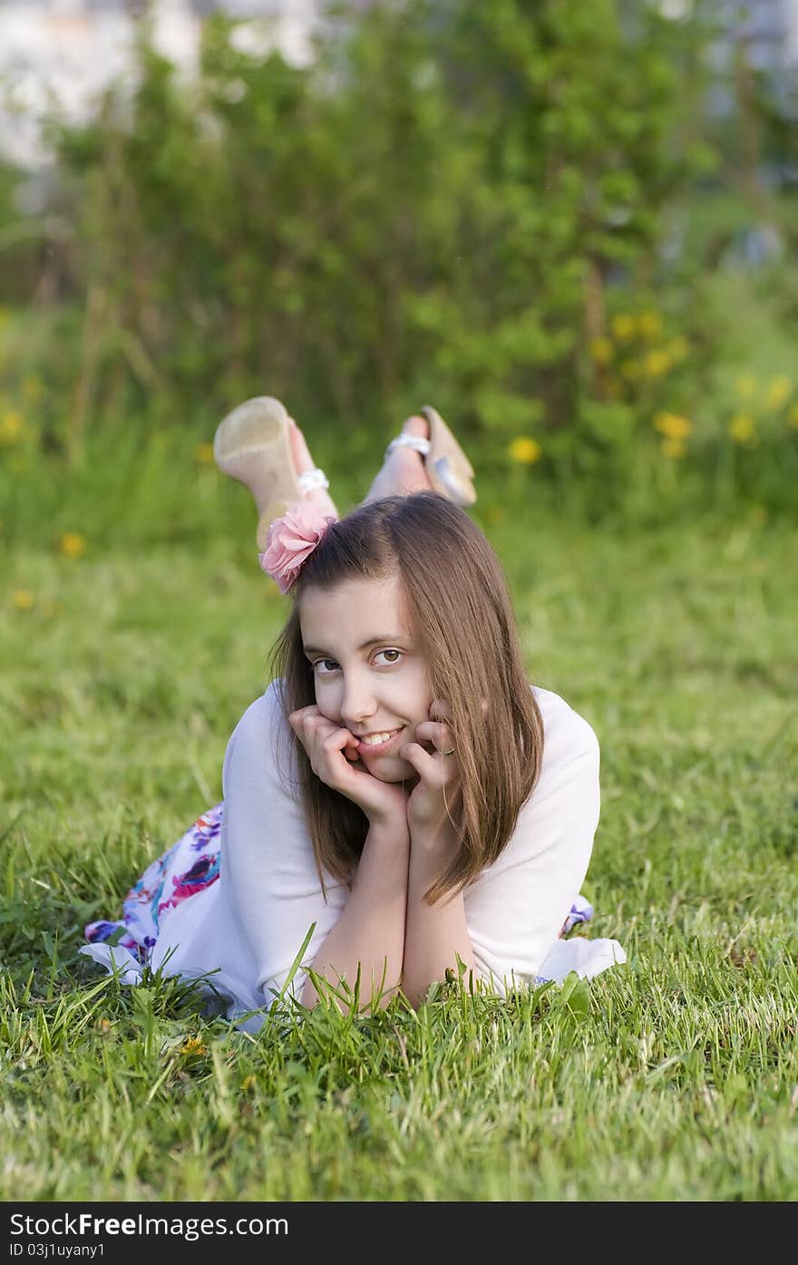 Smiling beautifull brunette on the spring grass. Smiling beautifull brunette on the spring grass