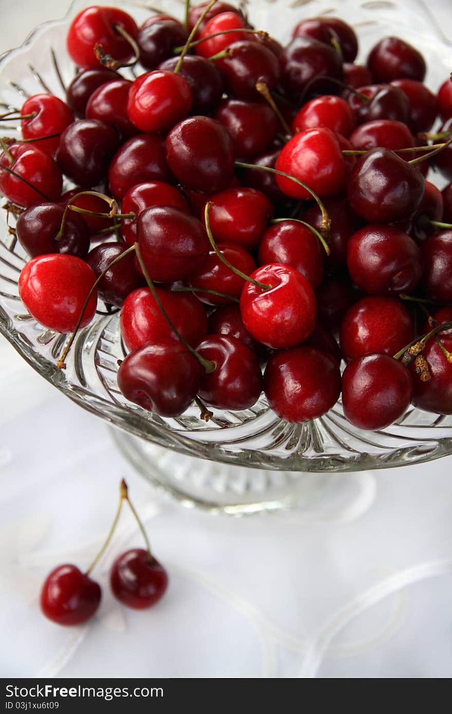 Sweet cherry in glass-ware on white background