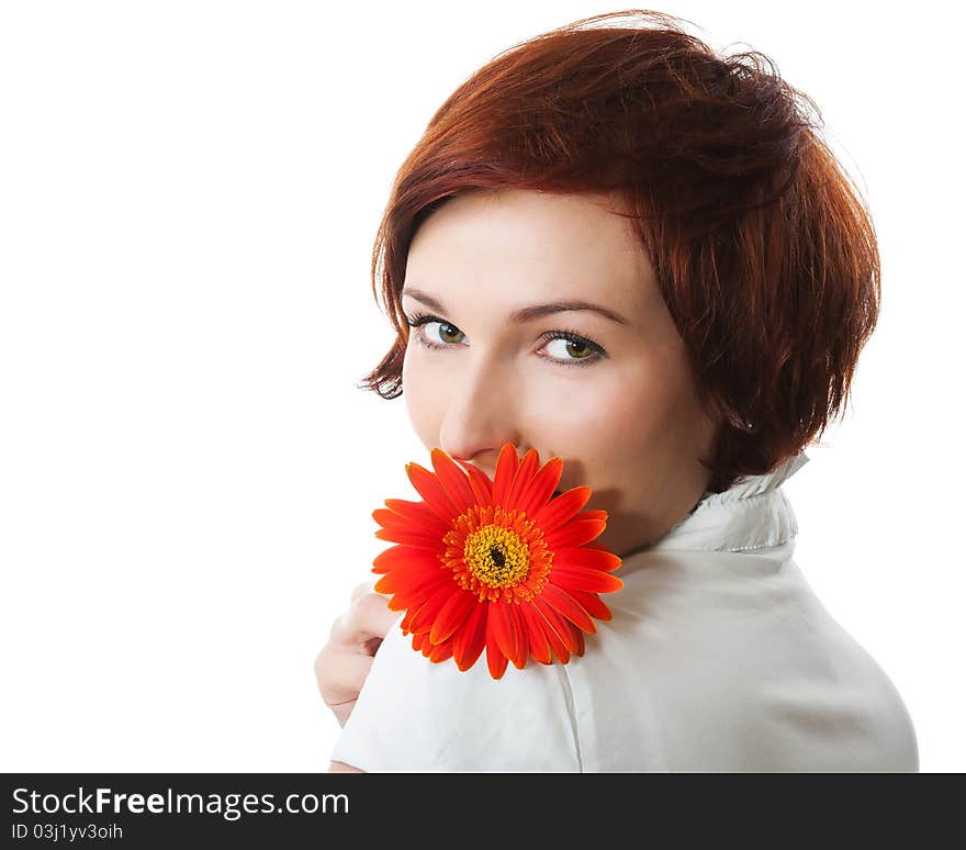 Beautiful woman with flower gerbera in her hands against white background