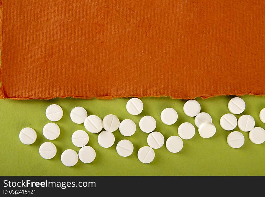 Pills background with orange and green paper