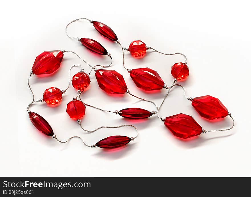 Rubine red glass diamonds necklace silver chain white background. Rubine red glass diamonds necklace silver chain white background