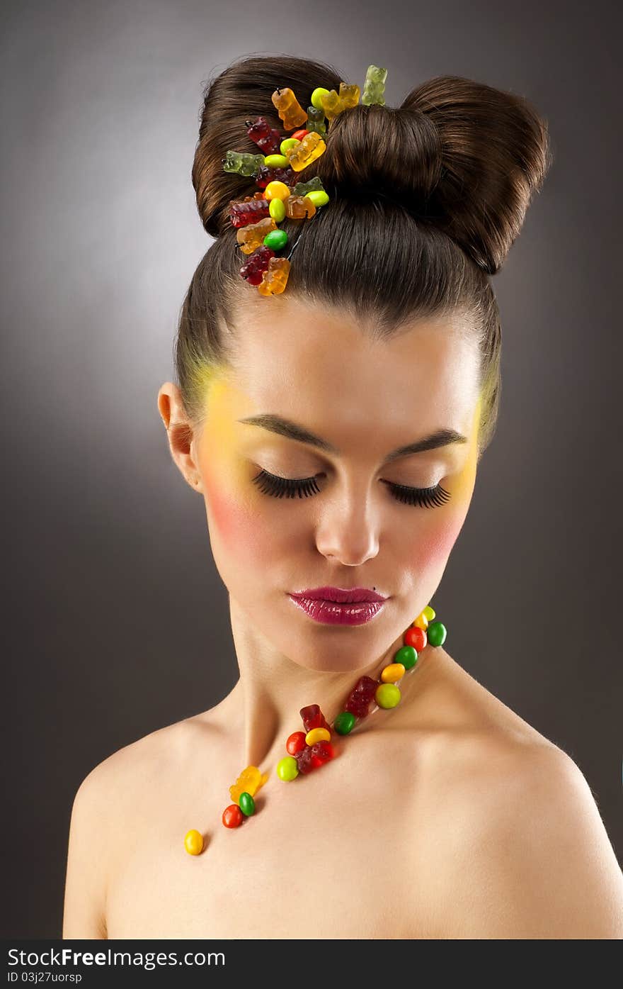 Close-up portrait of beautiful brunette with glamor make-up and color candy style