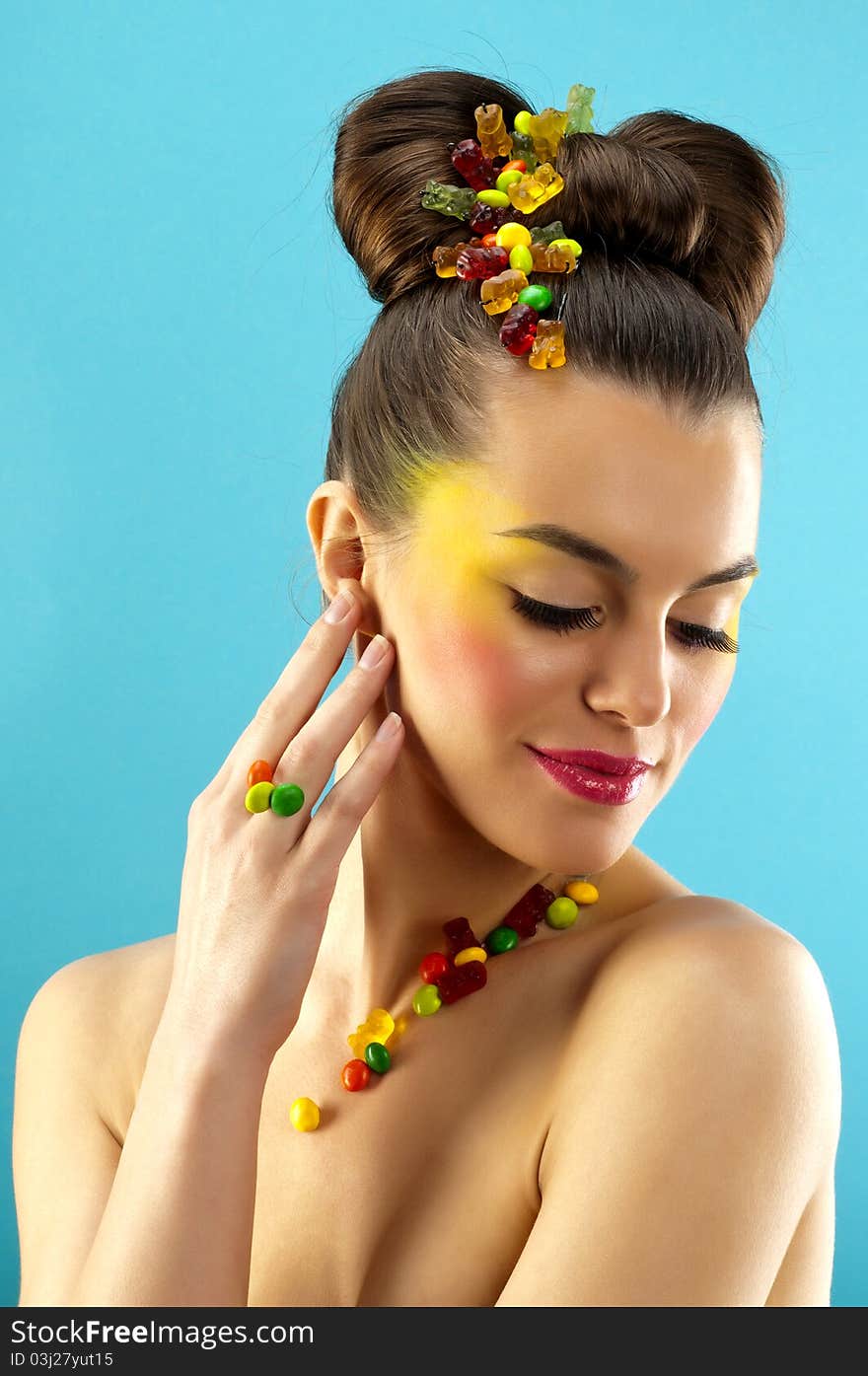 Close-up portrait of beautiful brunette with glamor make-up and color candy style