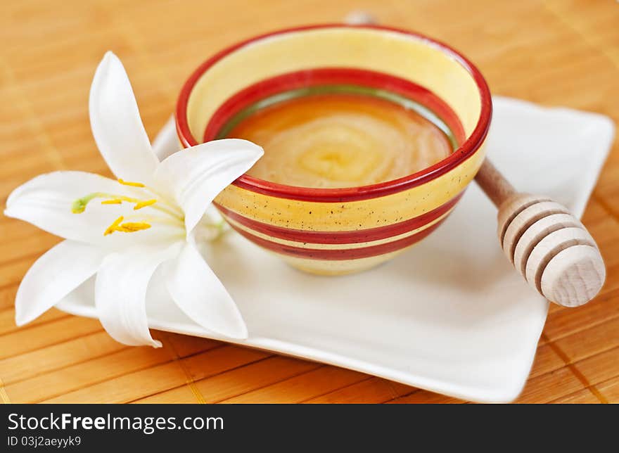 Pot of honey and a flower