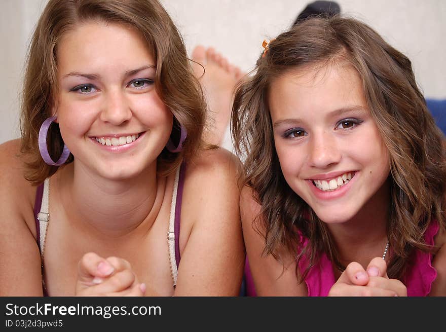 Teen girlfriends to be in bed and laughing. Teen girlfriends to be in bed and laughing