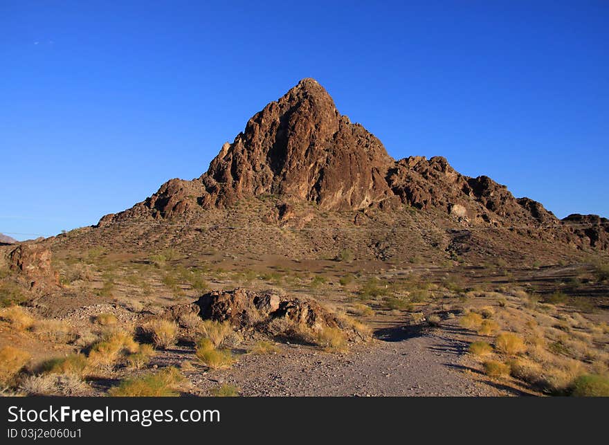 Sandstone butte in western Arizona against blue sky background