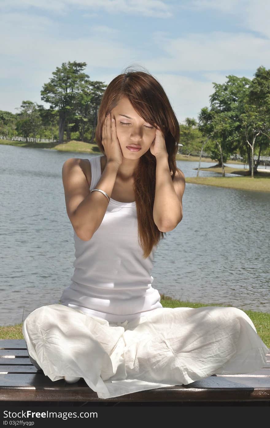 Young girl practicing yoga in the park