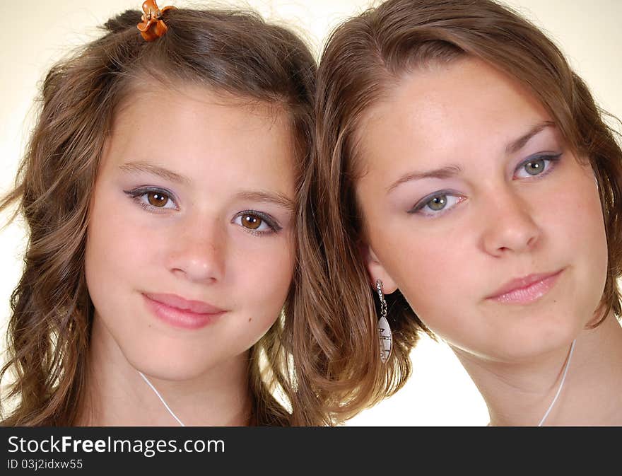 Two beautiful young women listening to their MP3 players. Two beautiful young women listening to their MP3 players