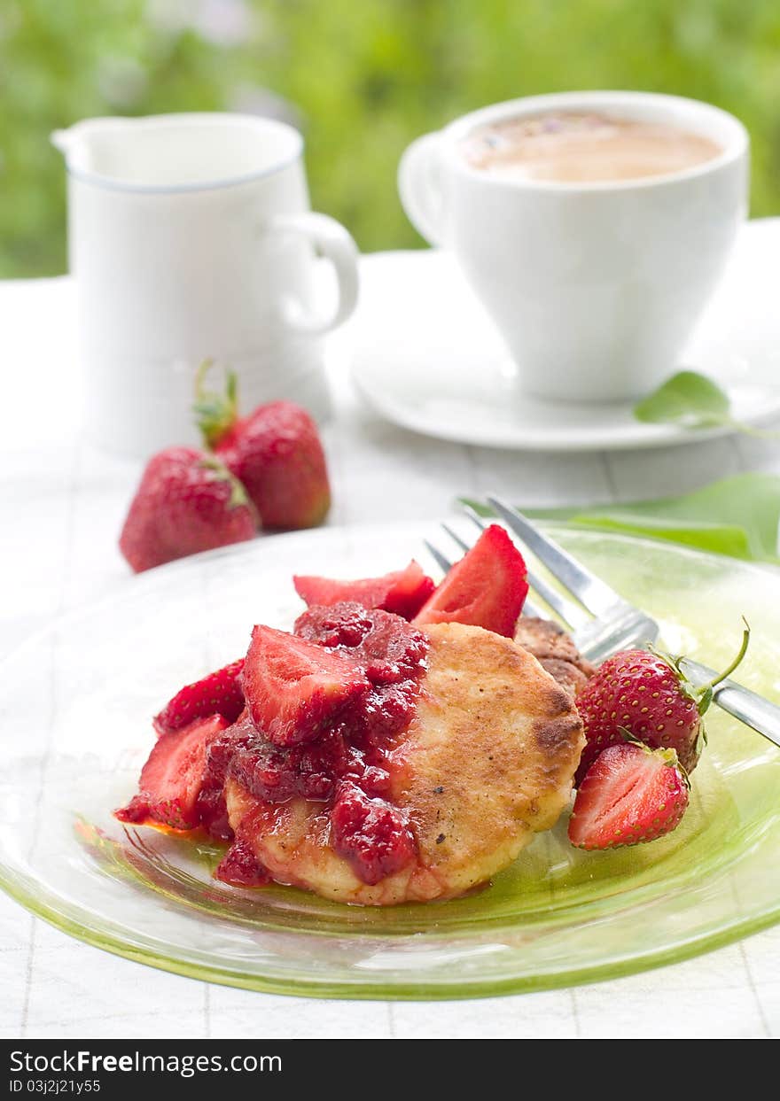 Pancakes with berries jam and fresh strawberry