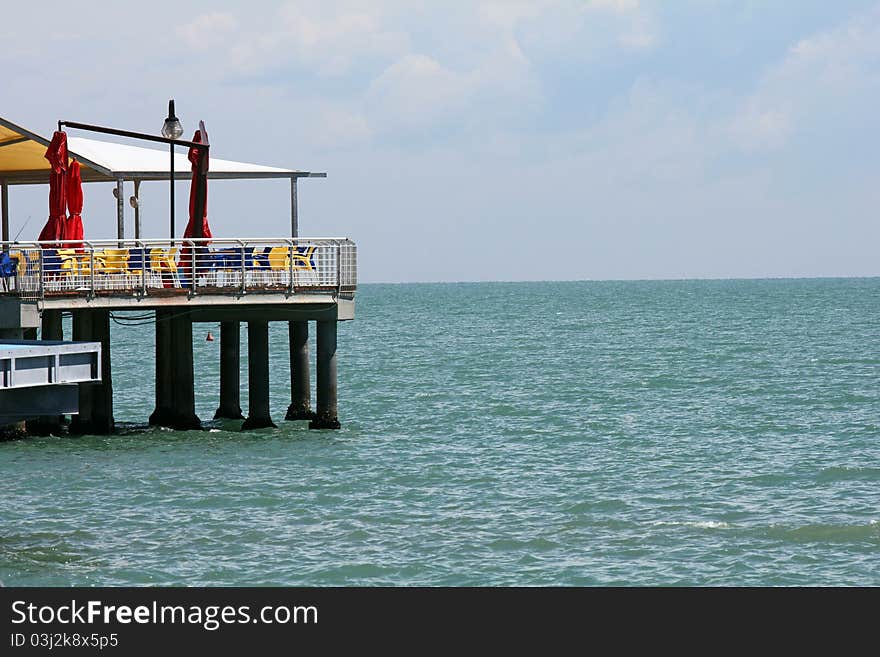 A restaurant at the beach which can be reached by a footbridge