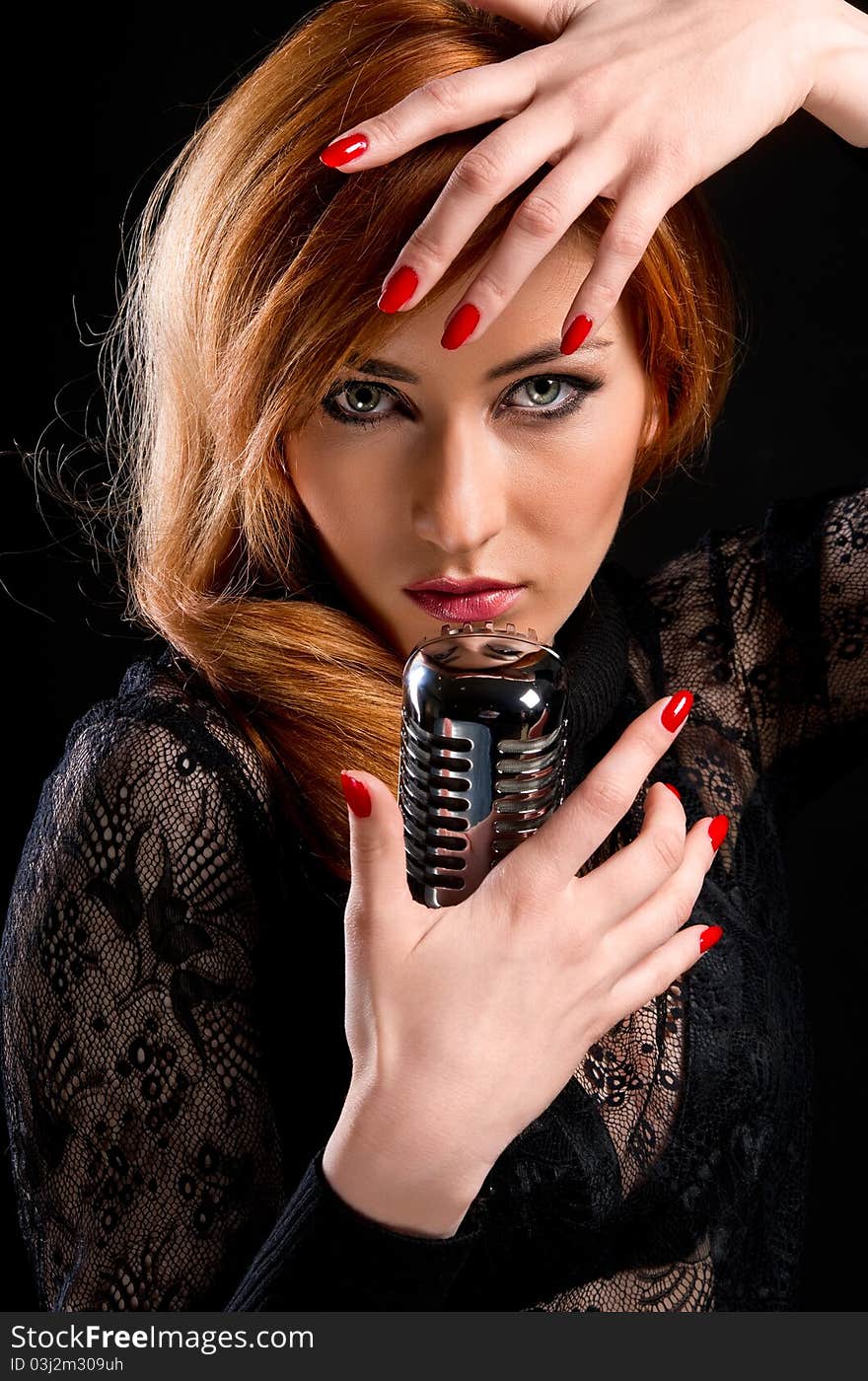 Gorgeous stylish redhead woman with retro microphone. Gorgeous stylish redhead woman with retro microphone