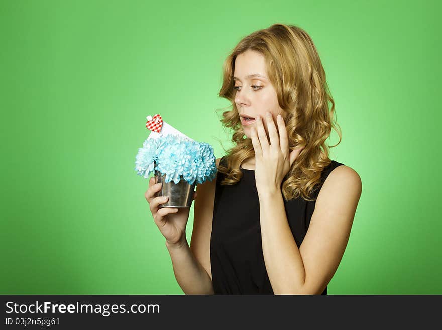 Close-up of an attractive young woman holding a gift bouquet of blue chrysanthemums. In flowers of a romantic note. Close-up of an attractive young woman holding a gift bouquet of blue chrysanthemums. In flowers of a romantic note