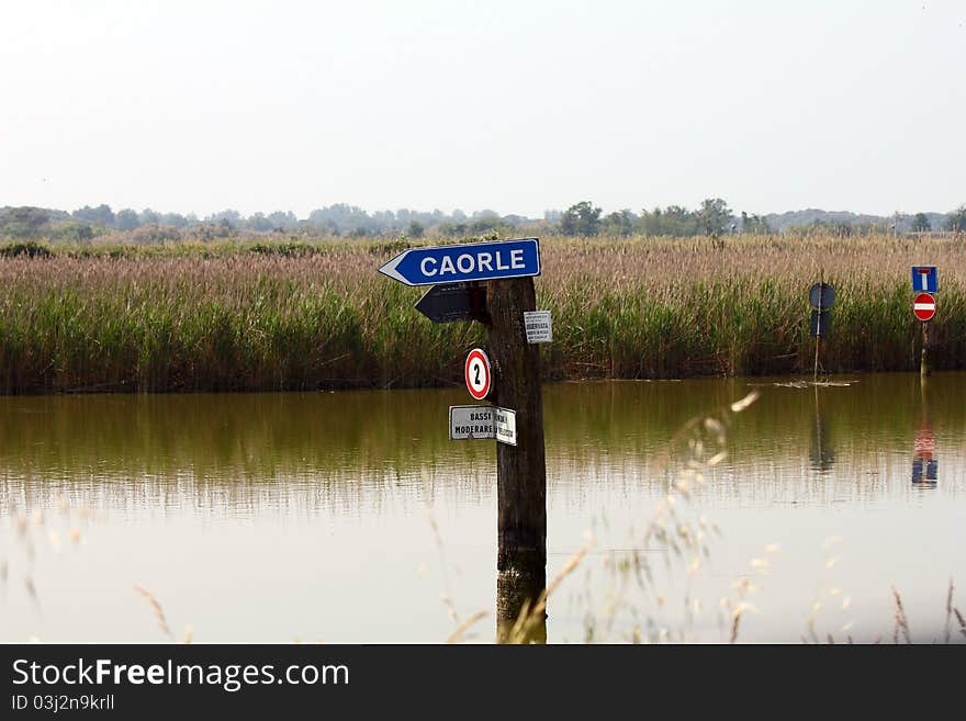 A sign in the river shows the way to the next city by boat. A sign in the river shows the way to the next city by boat