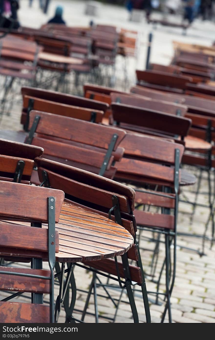 Tables of a closed restaurant in the rain. Tables of a closed restaurant in the rain