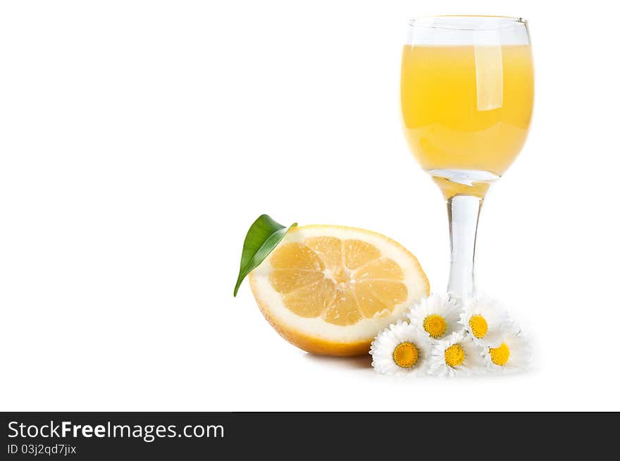 Lemon and juice in a glass isolated on a white background