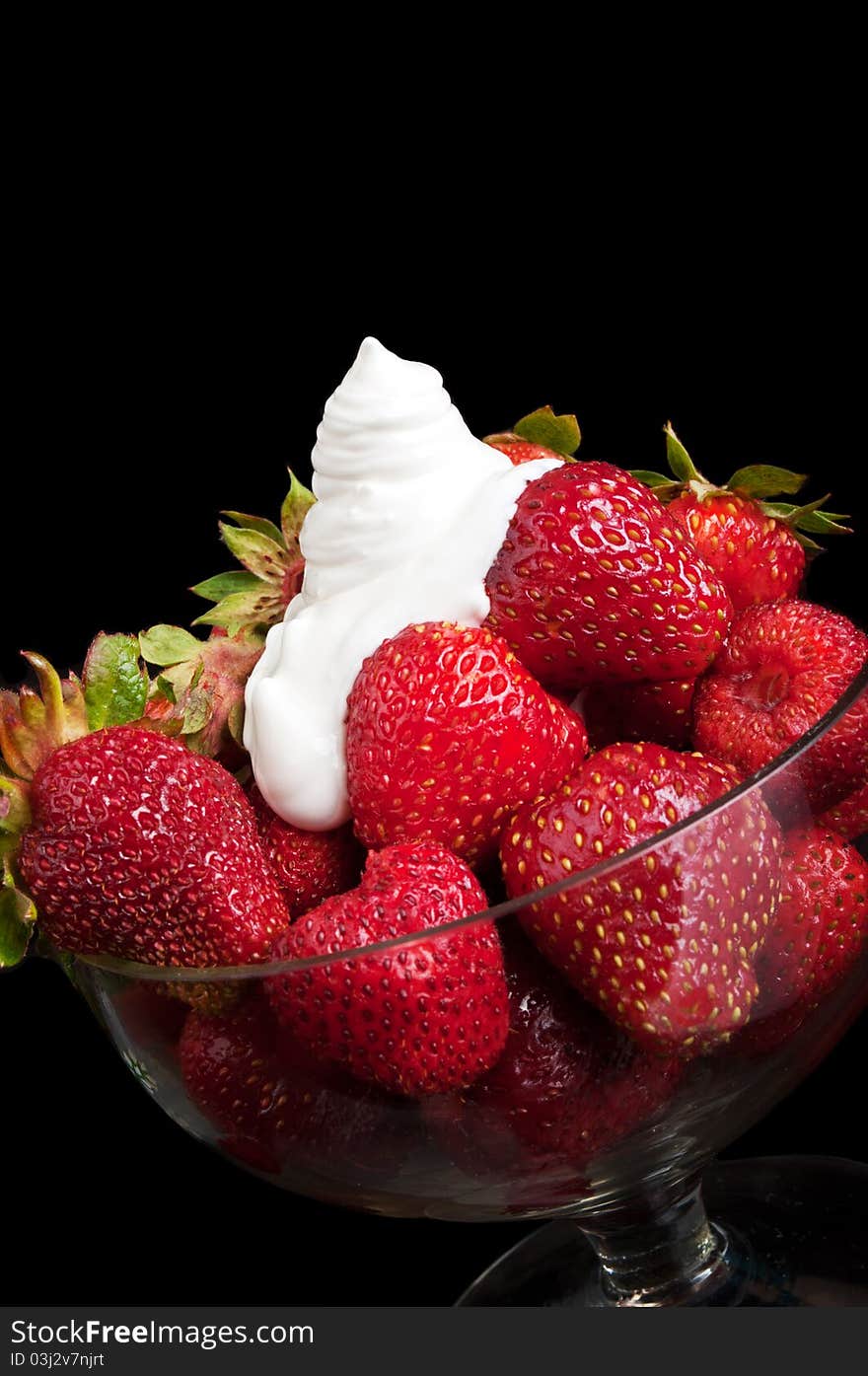 Appetizing strawberry and cream on a black background