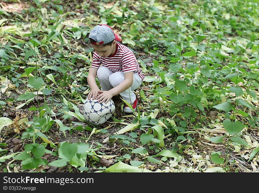 Boy outdoor with football ball. Boy outdoor with football ball.