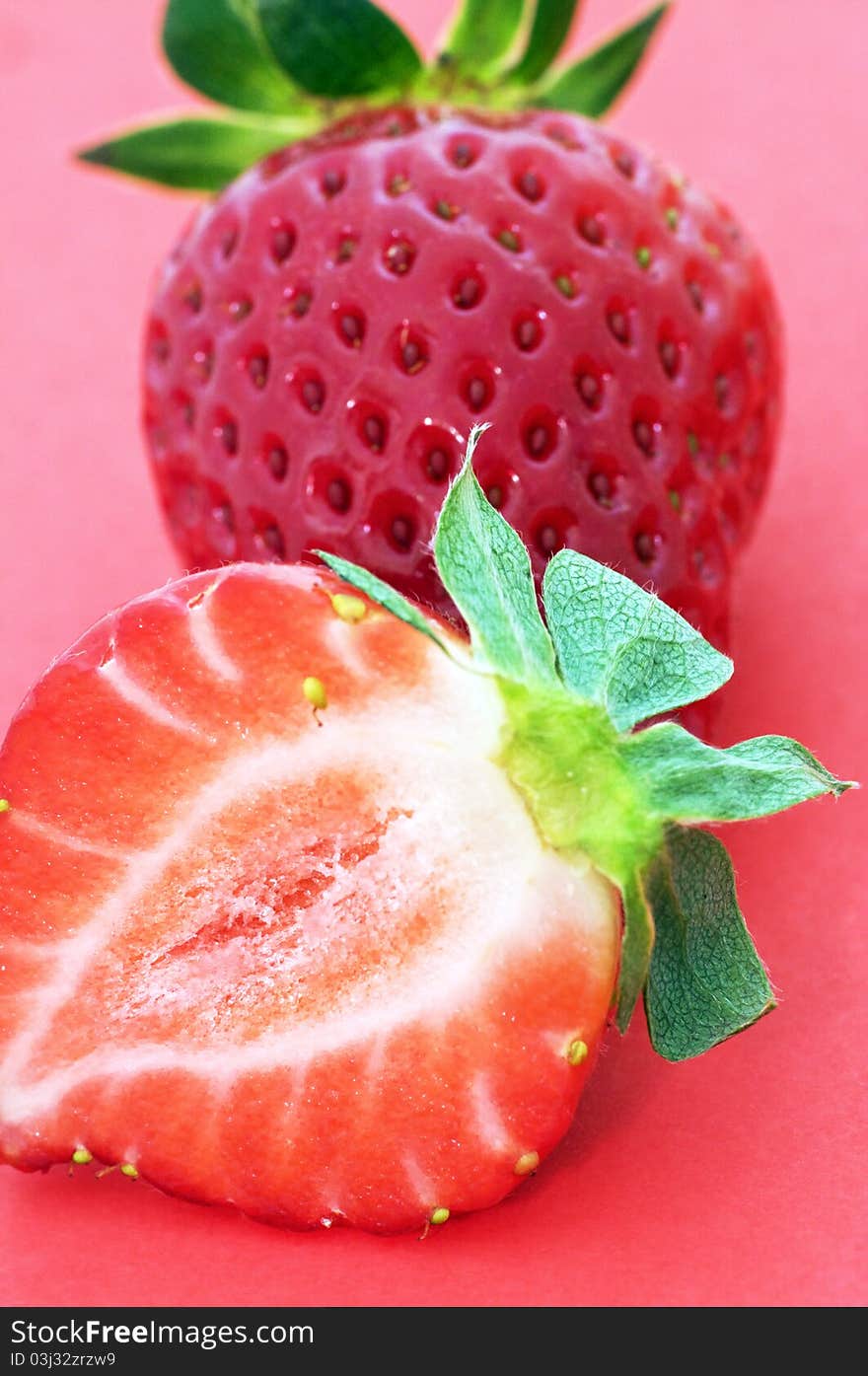 Ripen strawberry over red background