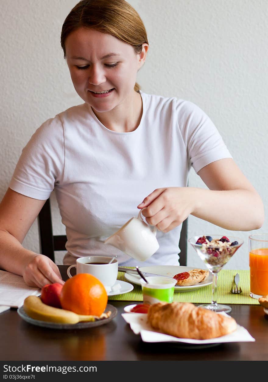 Woman Pouring Milk In Coffee