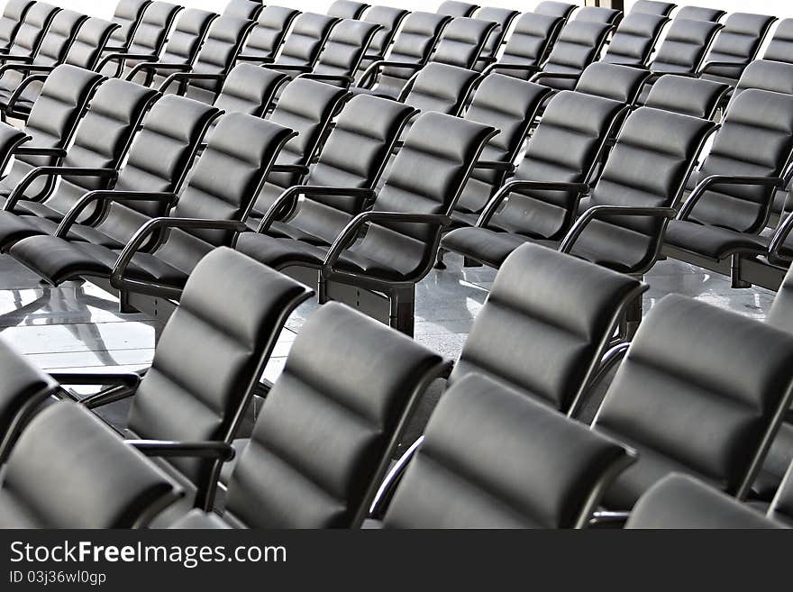 Empty Conference Hall or Waiting Space with black chairs