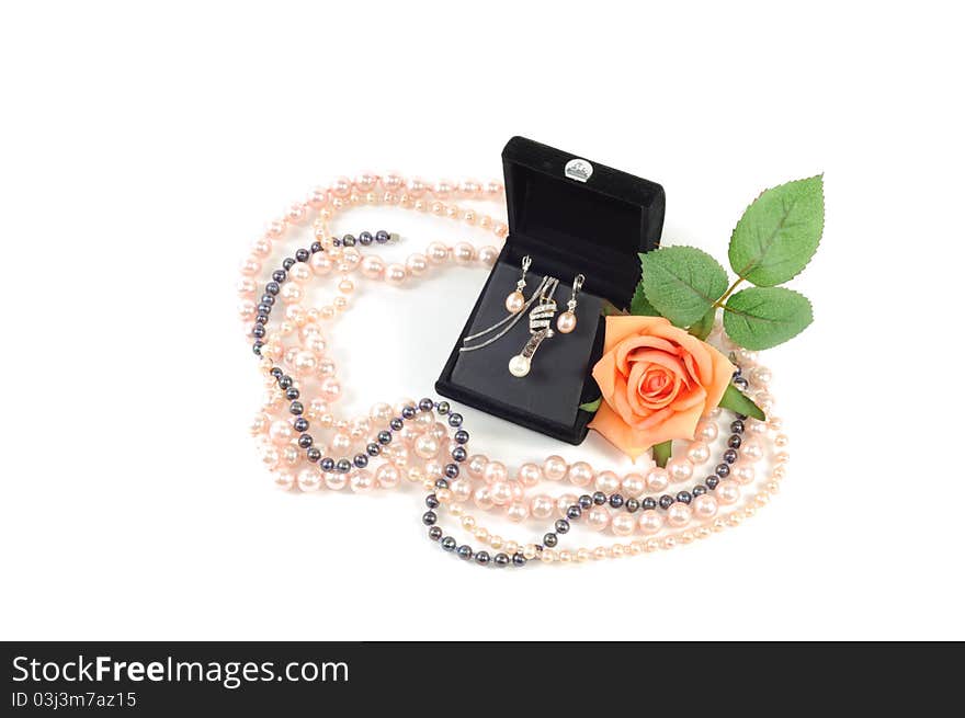 Precious pearls set in open gift box with yellow rose and pearl necklace