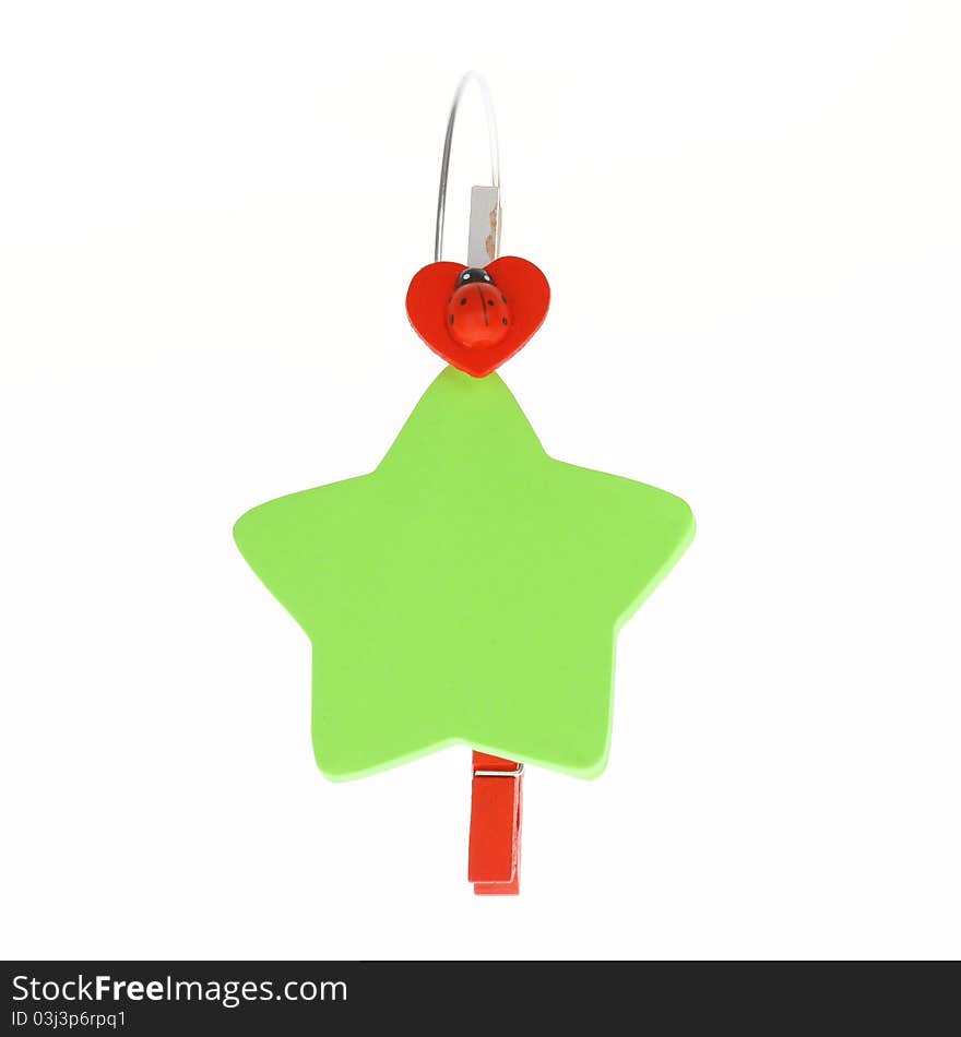 Colored green star paper and red clip on white background