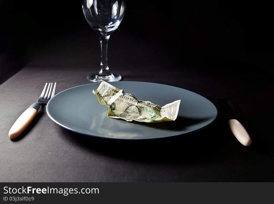 One dollar bill on a plate