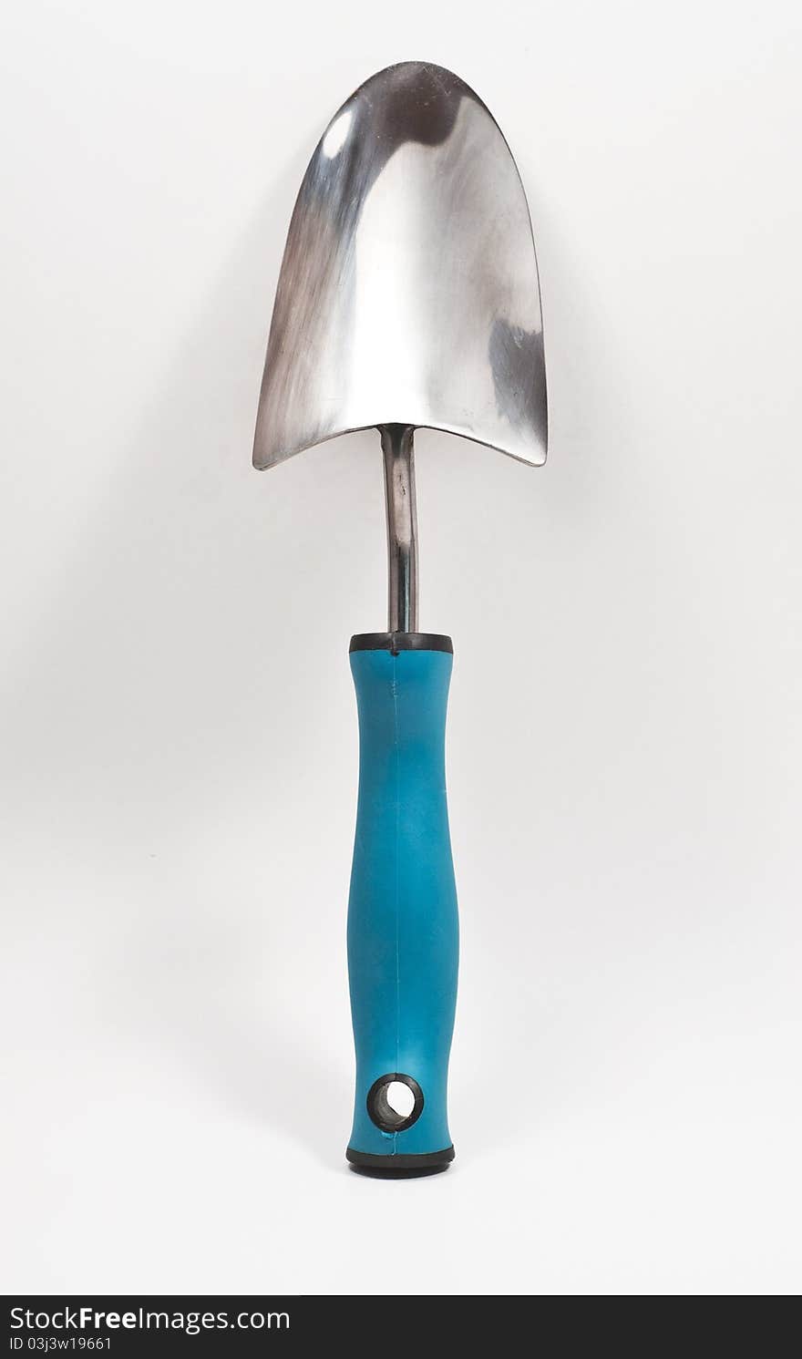 Garden trowel standing vertically against a white isolated background. Garden trowel standing vertically against a white isolated background