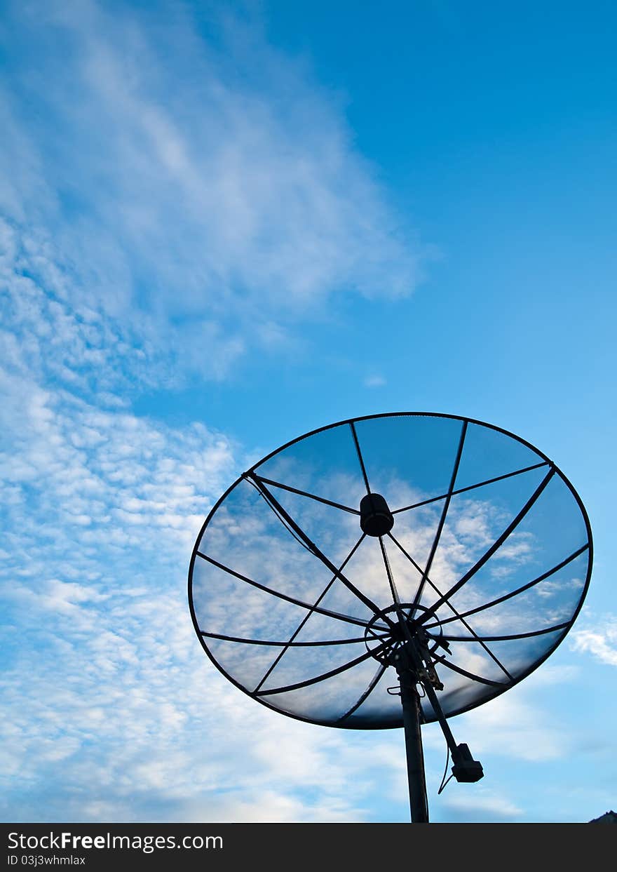 Satellite dish with blue sky on the background (vertical)