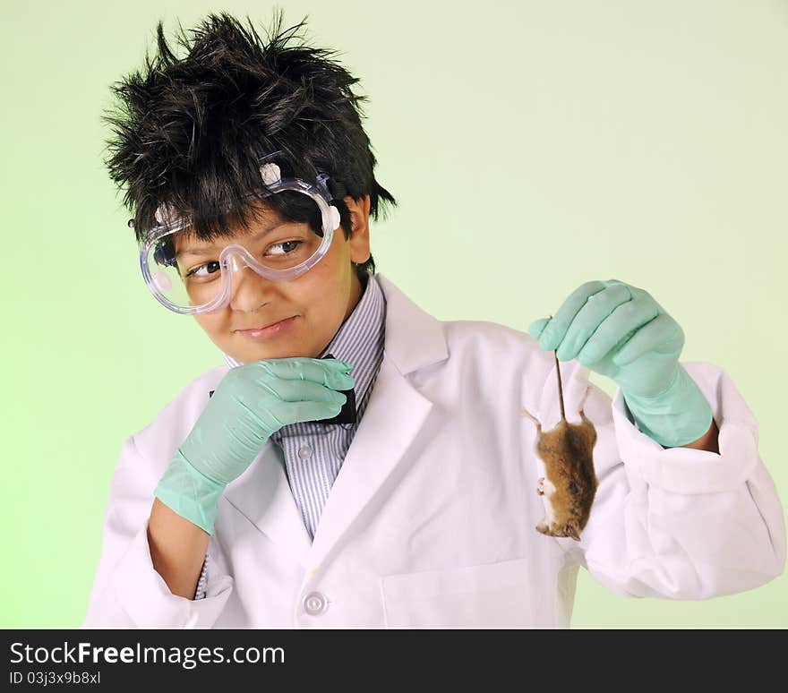 A young mad scientist skittishly examining the dead mouse he's holding by the tail. A young mad scientist skittishly examining the dead mouse he's holding by the tail.