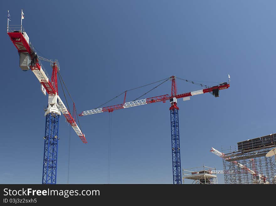 Red and white cranes on a construction site