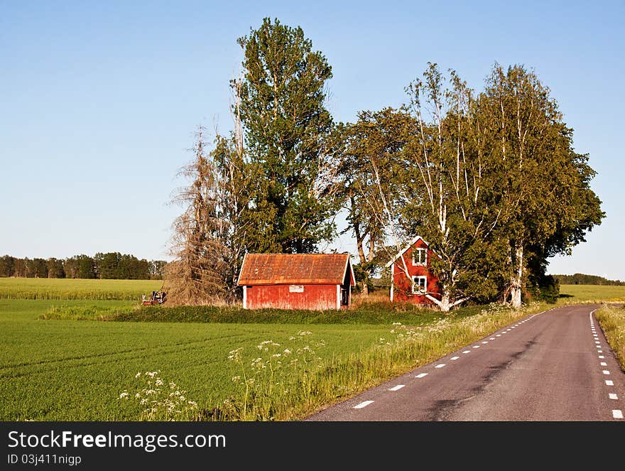 Red rural cottage att the road in Sweden. Red rural cottage att the road in Sweden.