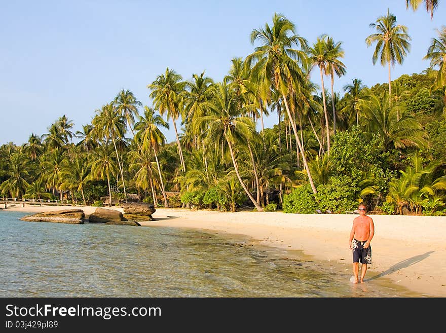 Man goes on an exotic beach . Thailand .