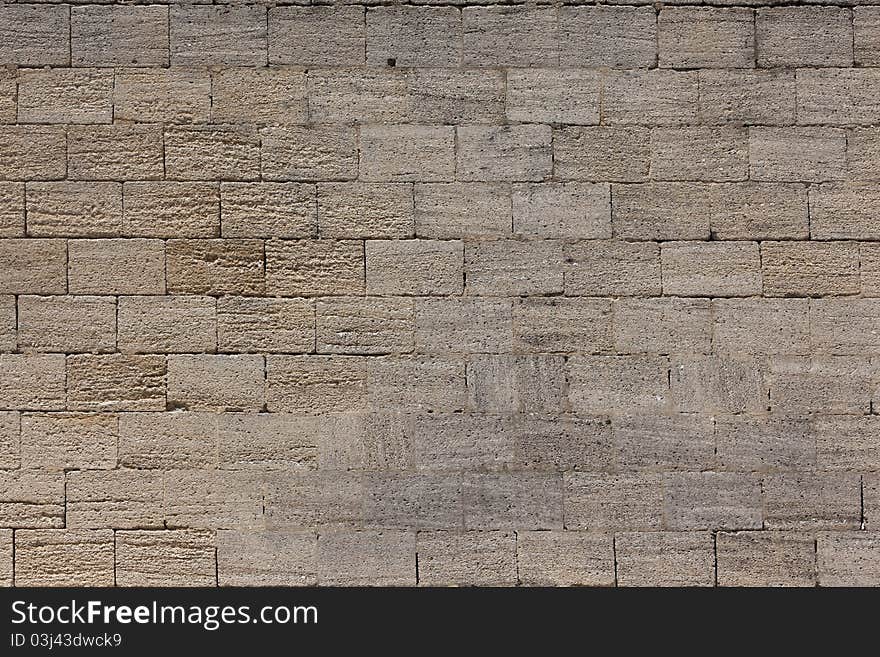 Front view of an old stone brick wall