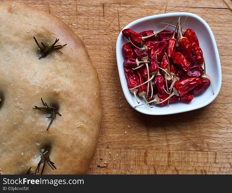 Focaccia bread and chillies on a bread board