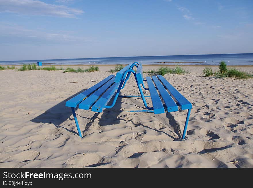 Blue bench on the bank of the Baltic beach. public place