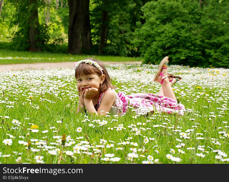 Pretty young girl lying on the grass