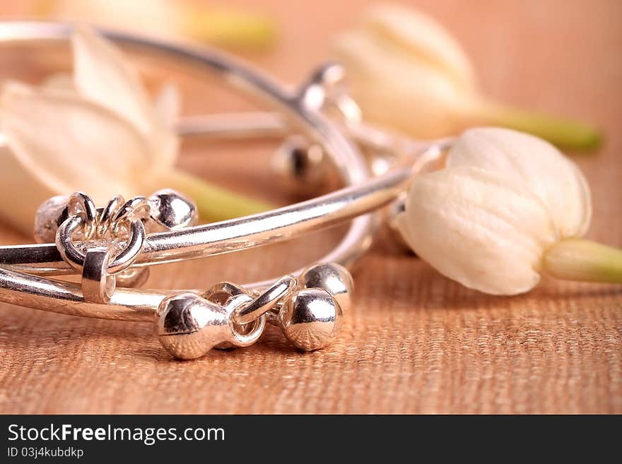 Child leg bracelet closeup with jasmine flowers