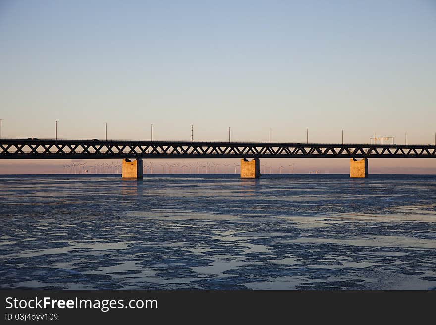 Oresund bridge viewed from land in sunset. Several wind turbines can be seen in the background. Oresund bridge viewed from land in sunset. Several wind turbines can be seen in the background