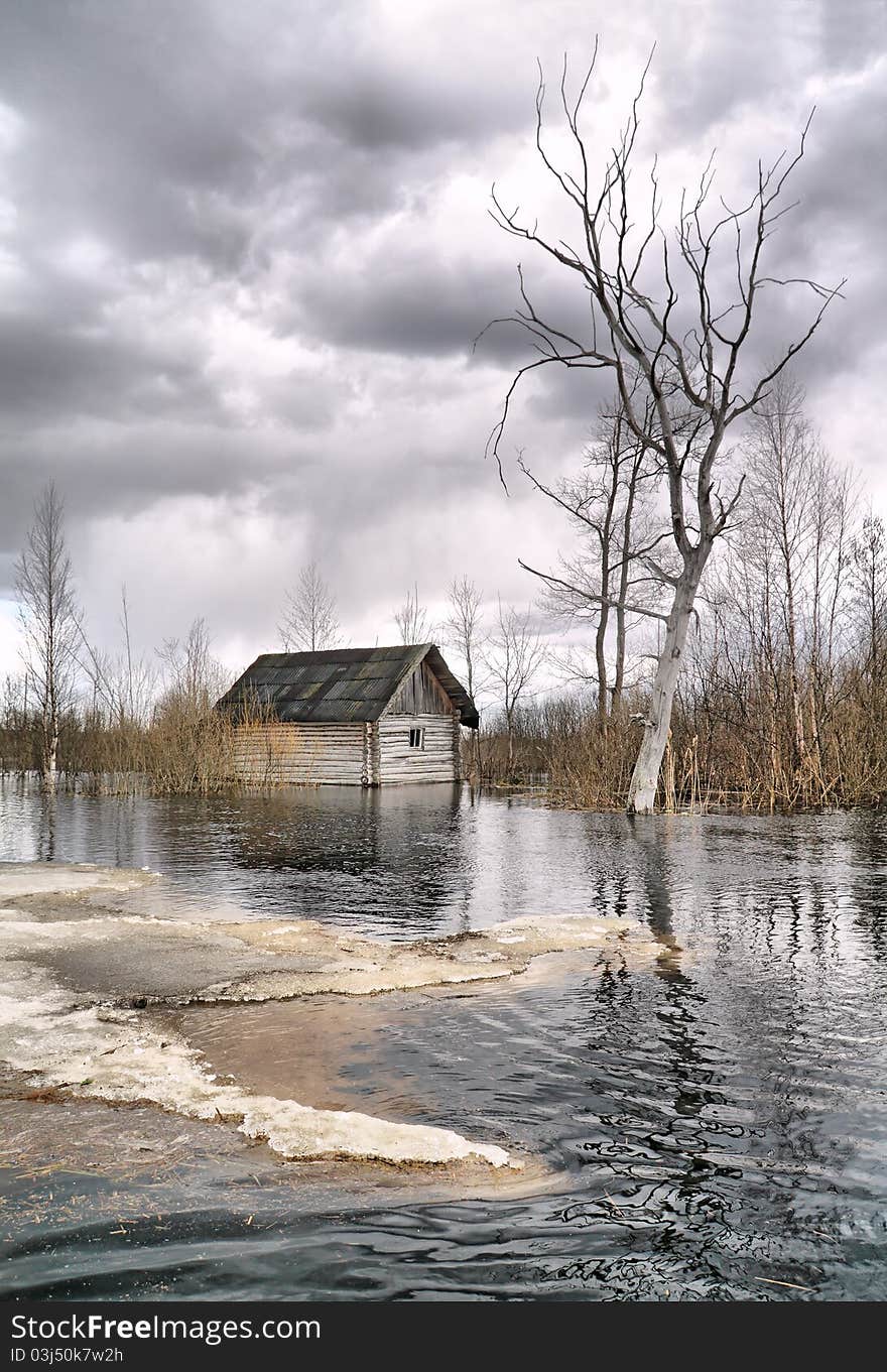 Old wooden house in water