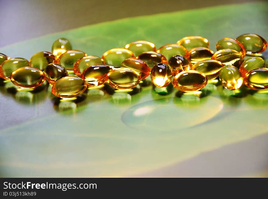 Yellow pills on green background