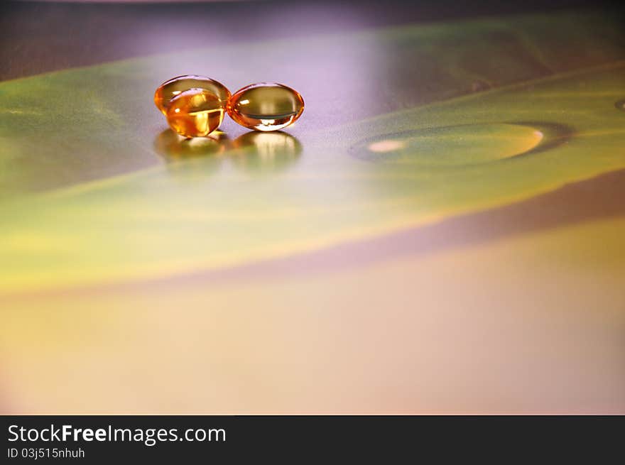 Yellow pills on green background, photography