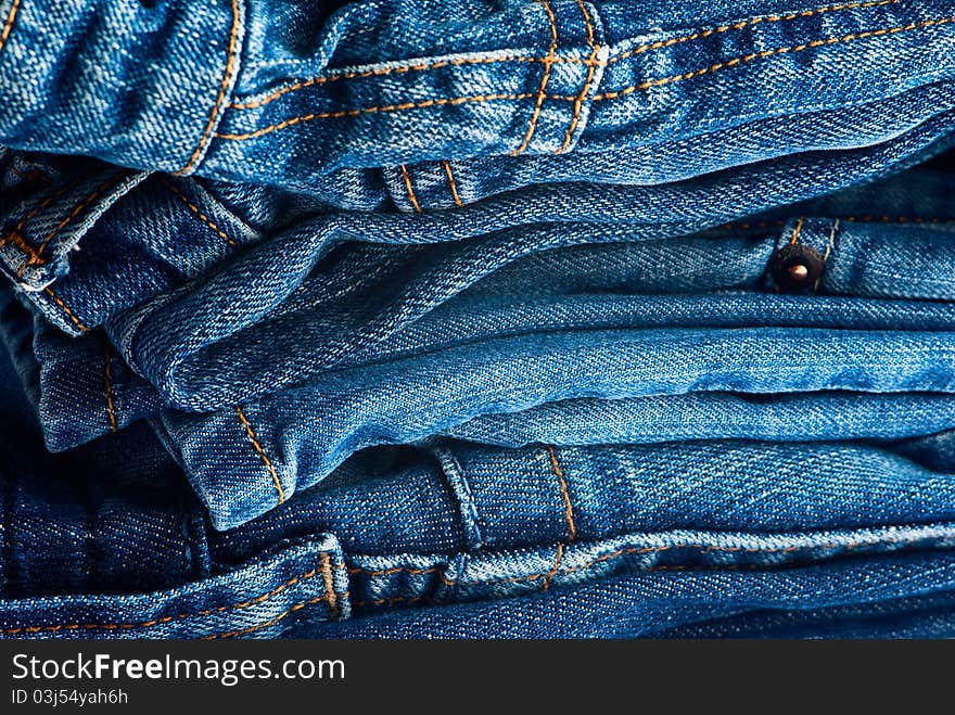 Big stack of blue jeans as a background. Big stack of blue jeans as a background