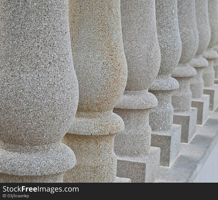 Solid stone pillars in a row with the second one in depicting the odd one out