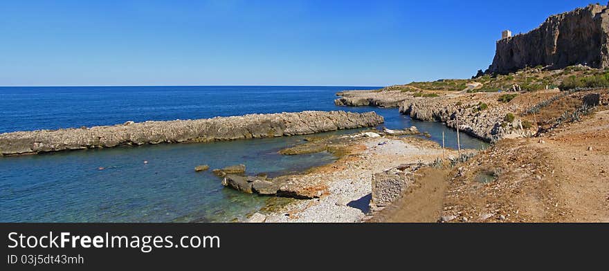 Beautiful natural landscape, view across the Macari Bay aof the Isuledda Beach and the watchtower Location: Macari Bay in Sicily, Italy, Europe Horizontal panoramic image, 2 horizontal images stitched together into a panoramic image. Beautiful natural landscape, view across the Macari Bay aof the Isuledda Beach and the watchtower Location: Macari Bay in Sicily, Italy, Europe Horizontal panoramic image, 2 horizontal images stitched together into a panoramic image