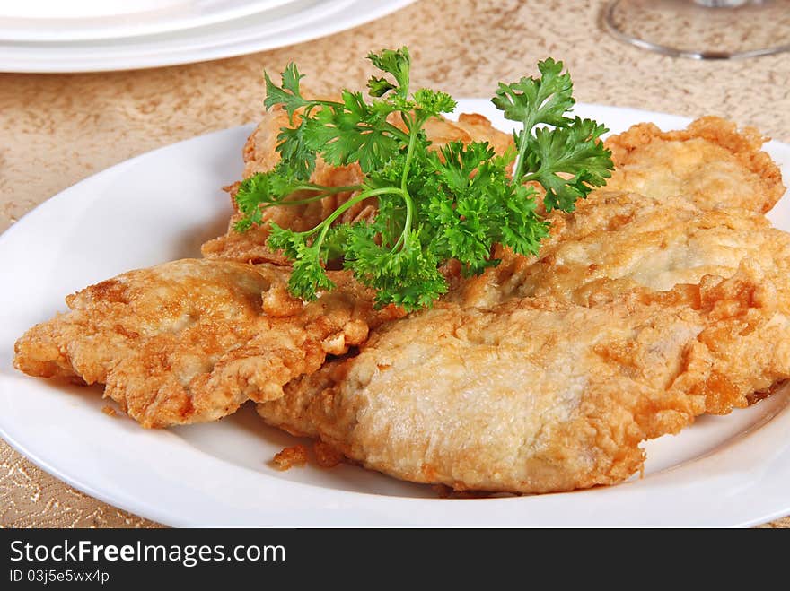 Meat chops on white plate. Close-up