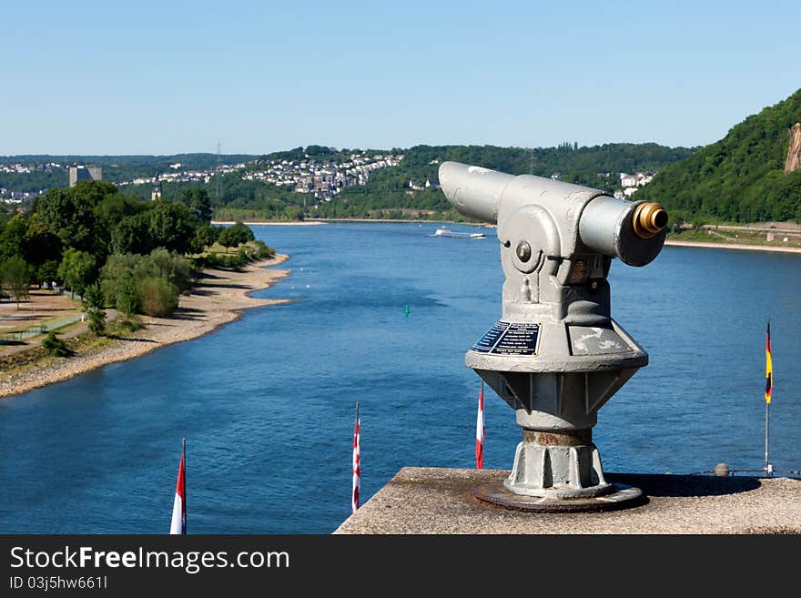 A telescope on top of an observation point at one of the most famous and scenic parts of the Rhine, the confluence with the Mosel River at Koblenz known as the German Corner (Deutsches Eck). A telescope on top of an observation point at one of the most famous and scenic parts of the Rhine, the confluence with the Mosel River at Koblenz known as the German Corner (Deutsches Eck)